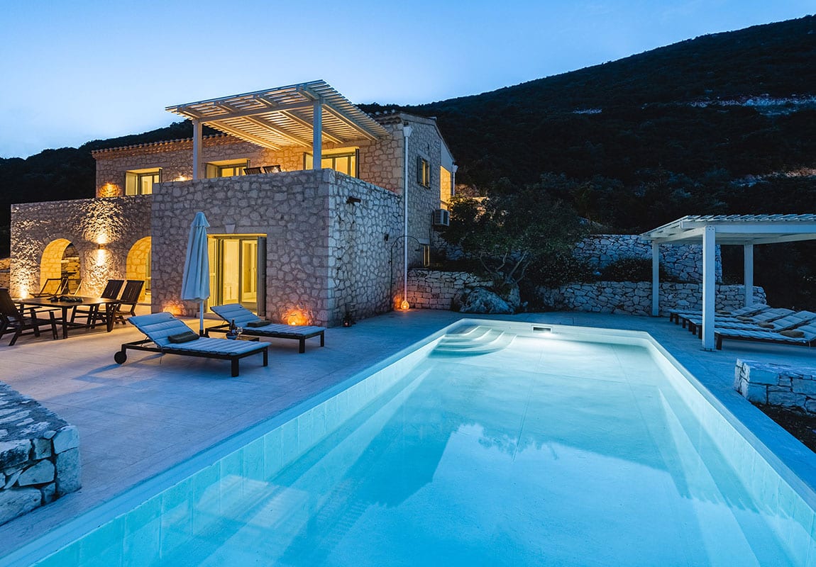 Urania Villas Lefkada Greece - Villa Helios Lefkada night shot of the pool area, the villa and the large exterior spaces