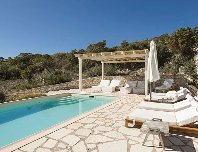 Pool view facing the wooden and pillow sunbeds